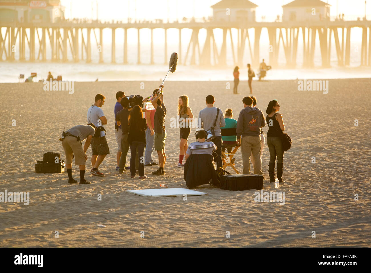 Film, cast, t.v. crew sur un emplacement de plage au coucher du soleil lever du soleil Banque D'Images