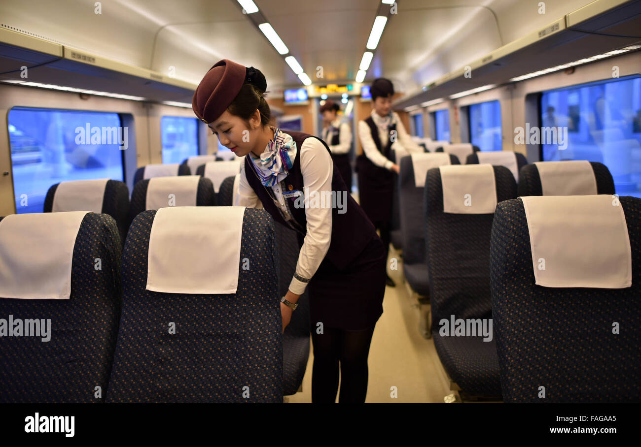 Haikou, province de Hainan en Chine. Dec 30, 2015. Steward organiser sièges pour les passagers d'un train à la gare de Haikou Haikou, capitale de la province de Hainan en Chine du Sud, 30 décembre 2015. Les 345 km de chemin de fer de l'ouest de l'anneau à Hainan a été mis en service le mercredi, complétant la première ligne de train à grande vitesse autour d'une île. Le tronçon ouest, conçu avec une vitesse de 200 km par heure, a 16 s'arrête dans six villes et comtés, reliant la capitale provinciale Haikou avec Sanya, un endroit touristique tropical. Credit : Zhao Yingquan/Xinhua/Alamy Live News Banque D'Images