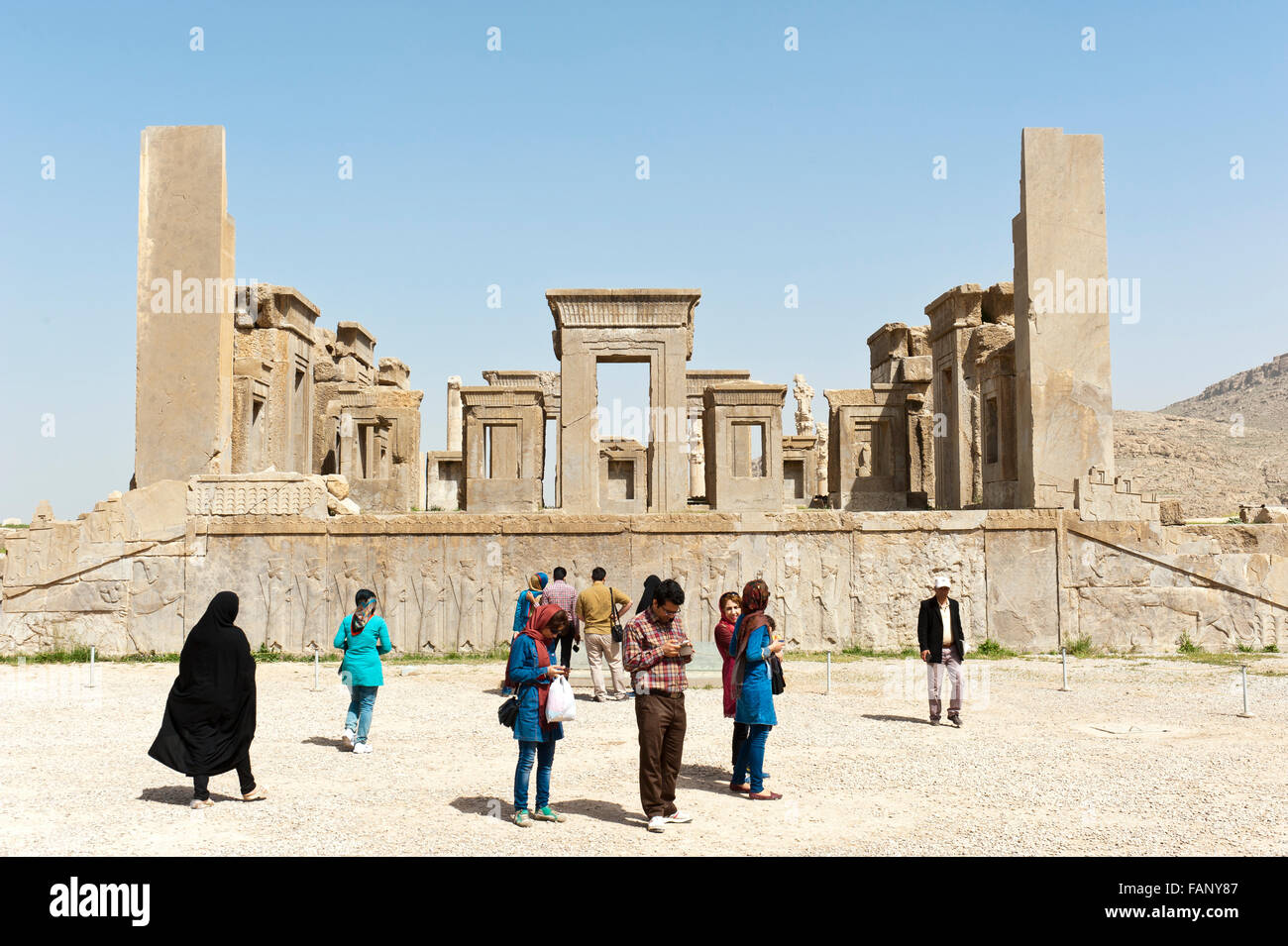 Les touristes, de secours avec les gardiens des portes, les chiffres en ruines, palais de Xerxès, ville de la Perse antique de Persépolis Banque D'Images