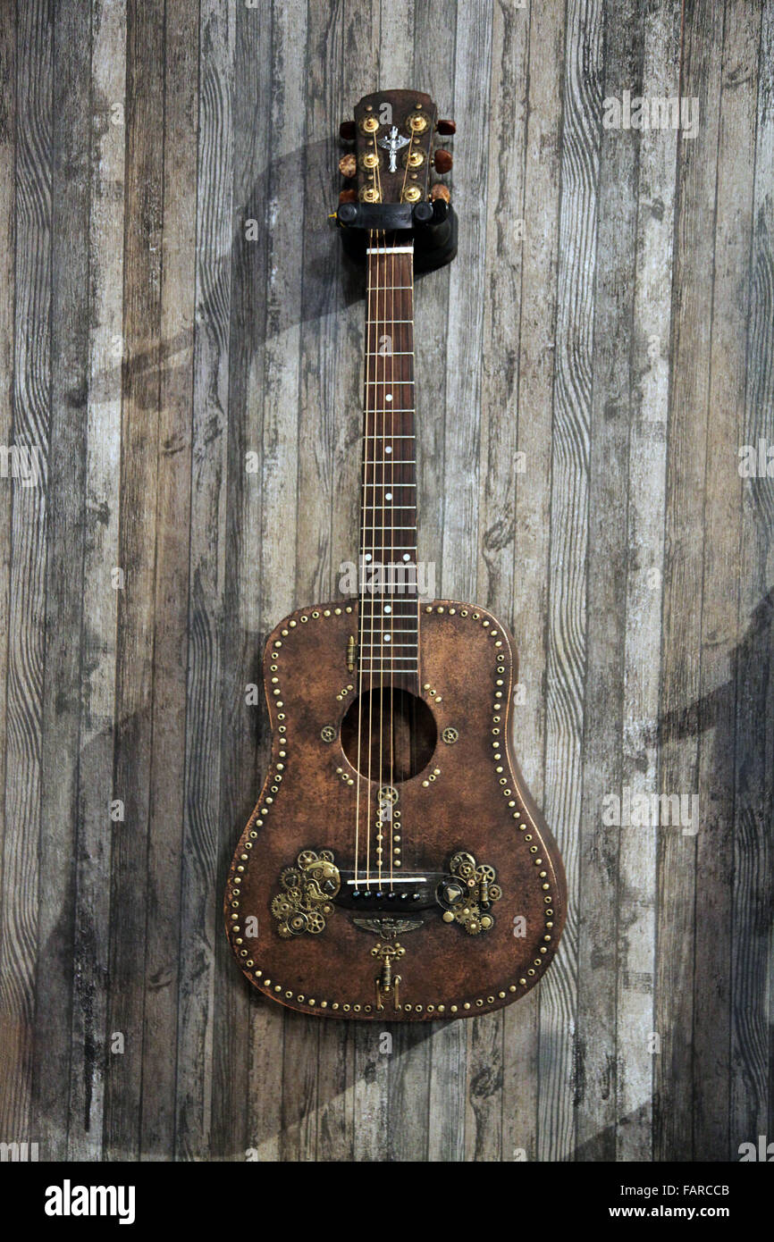 C'est une photo d'une guitare musique instrument qui est accroché à un mur en bois Banque D'Images