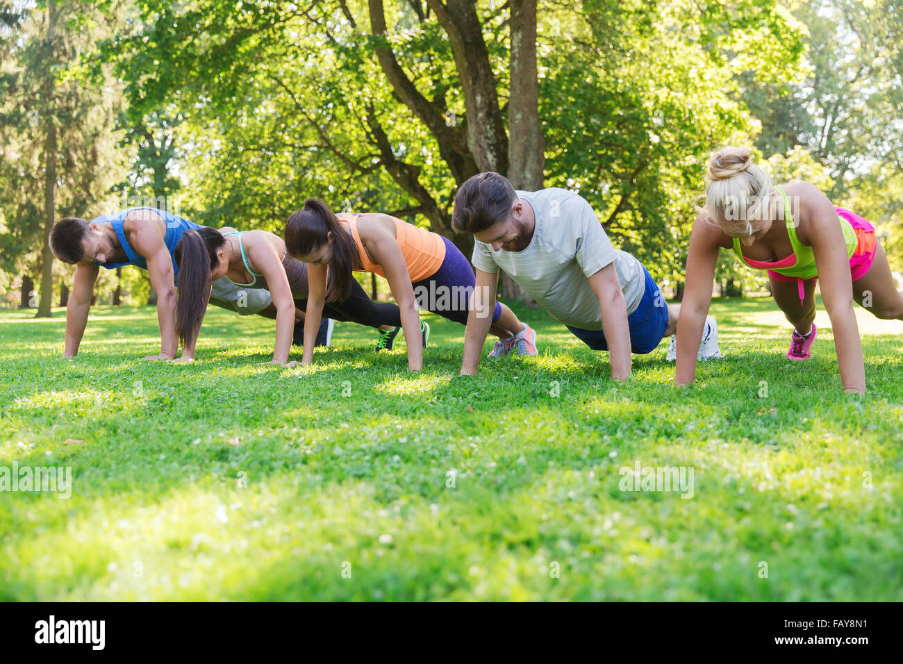 Groupe d'amis ou les sportifs exercising outdoors Banque D'Images