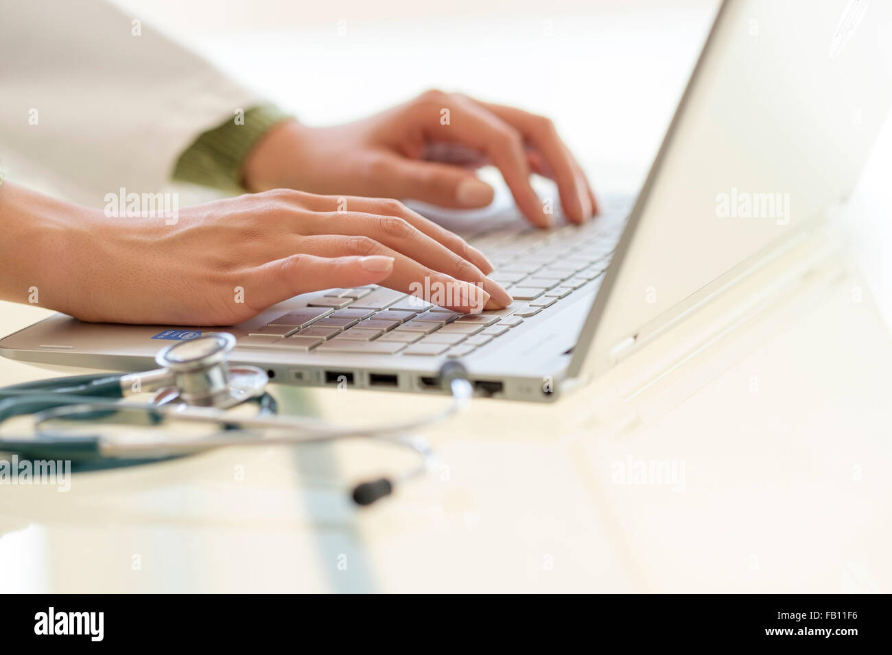 Hands typing on laptop keyboard Banque D'Images