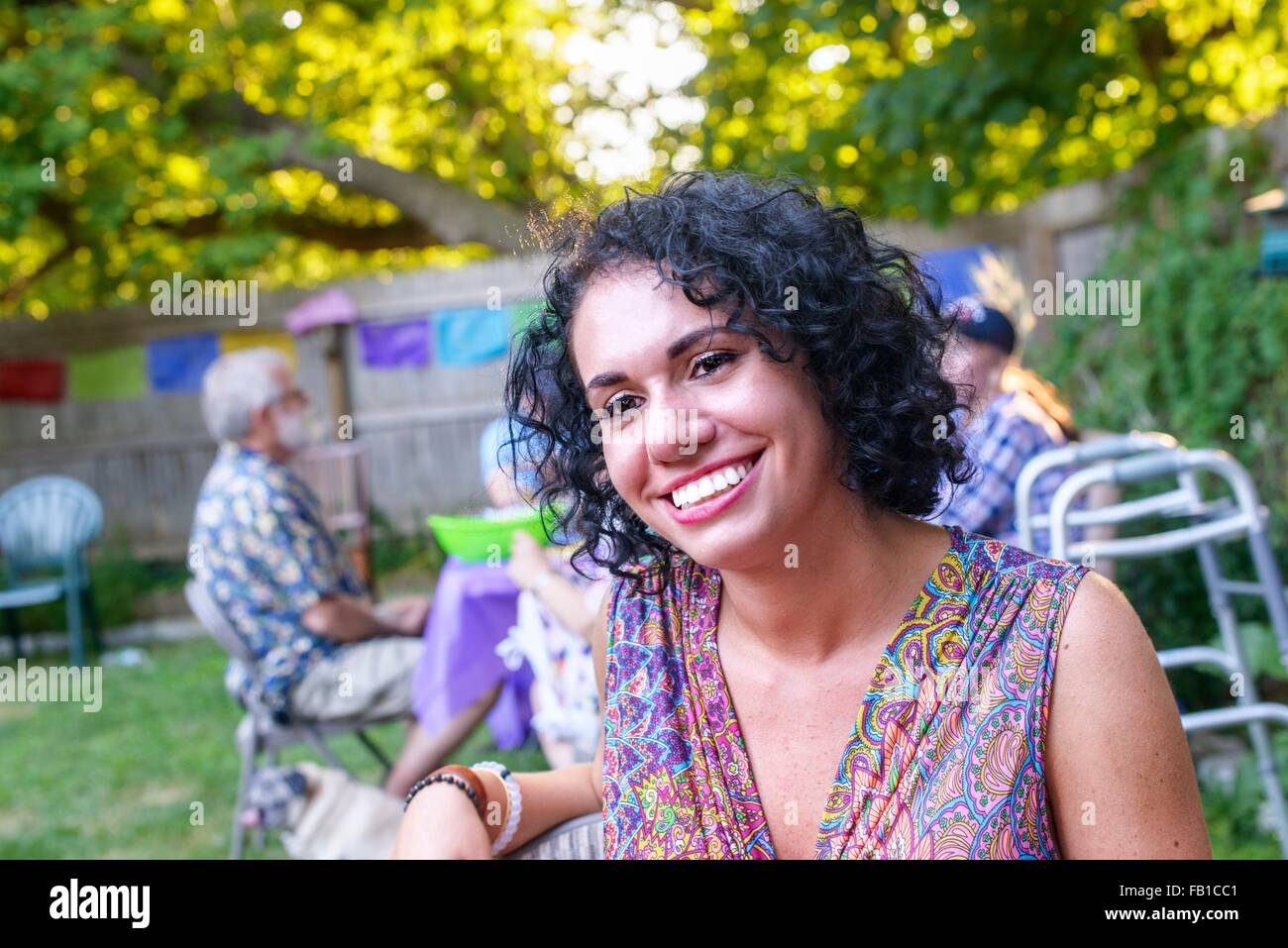 Portrait of happy young woman at party in garden Banque D'Images