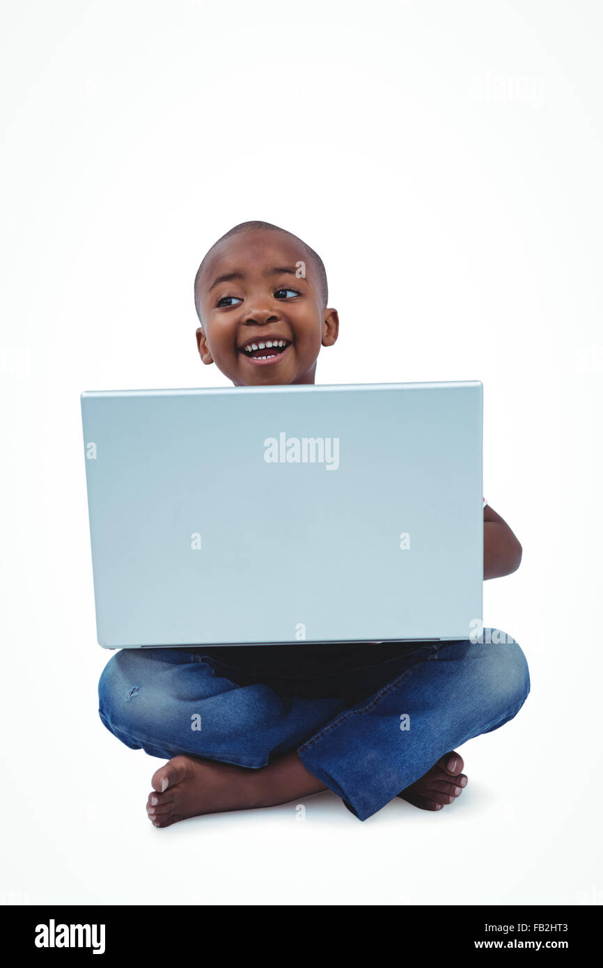 Assis boy using laptop Banque D'Images