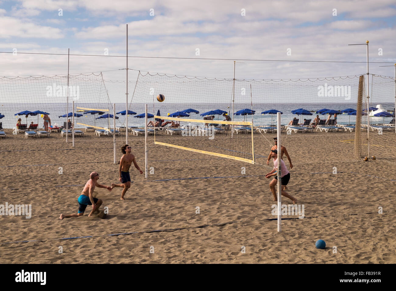 Des groupes de jeunes de jouer au beach-volley sur la plage de Las Vistas à Los Cristianos, Tenerife, Canaries, Espagne. Banque D'Images