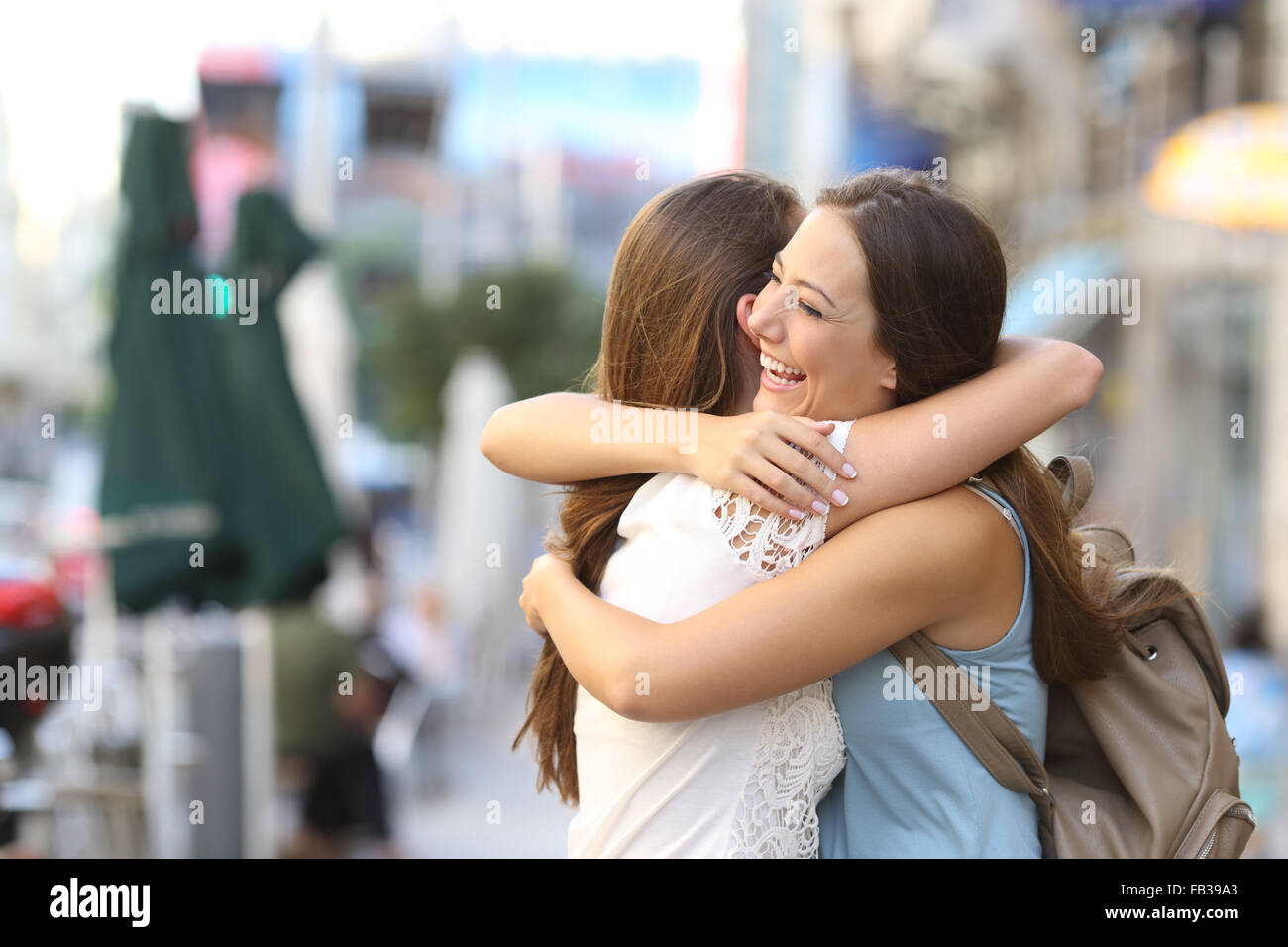 Heureuse rencontre de deux friends hugging dans la rue Banque D'Images