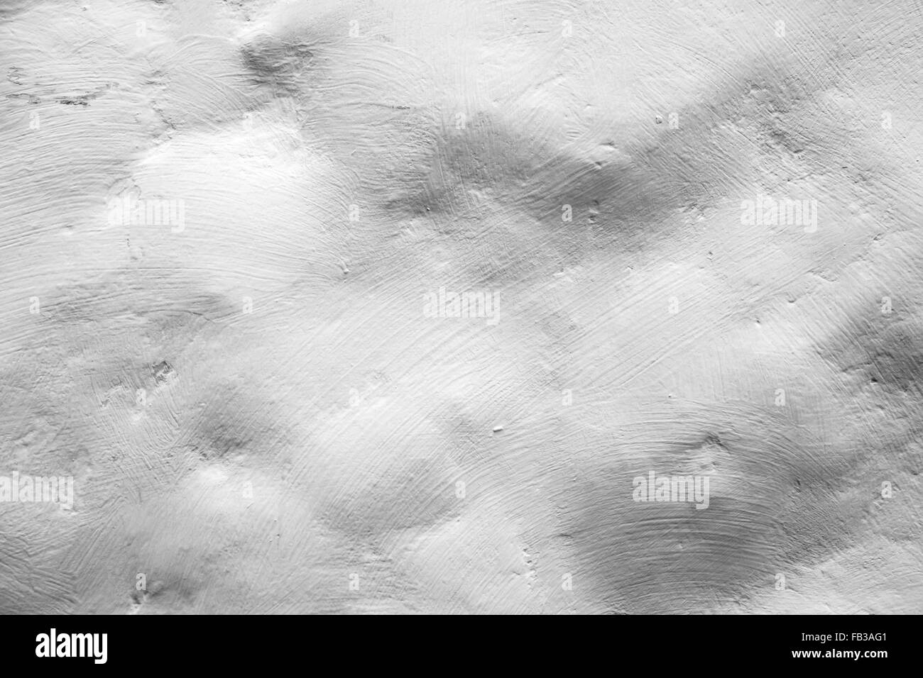 Mur de pierres peintes en blanc et rugueux, texture de fond photo gros plan Banque D'Images