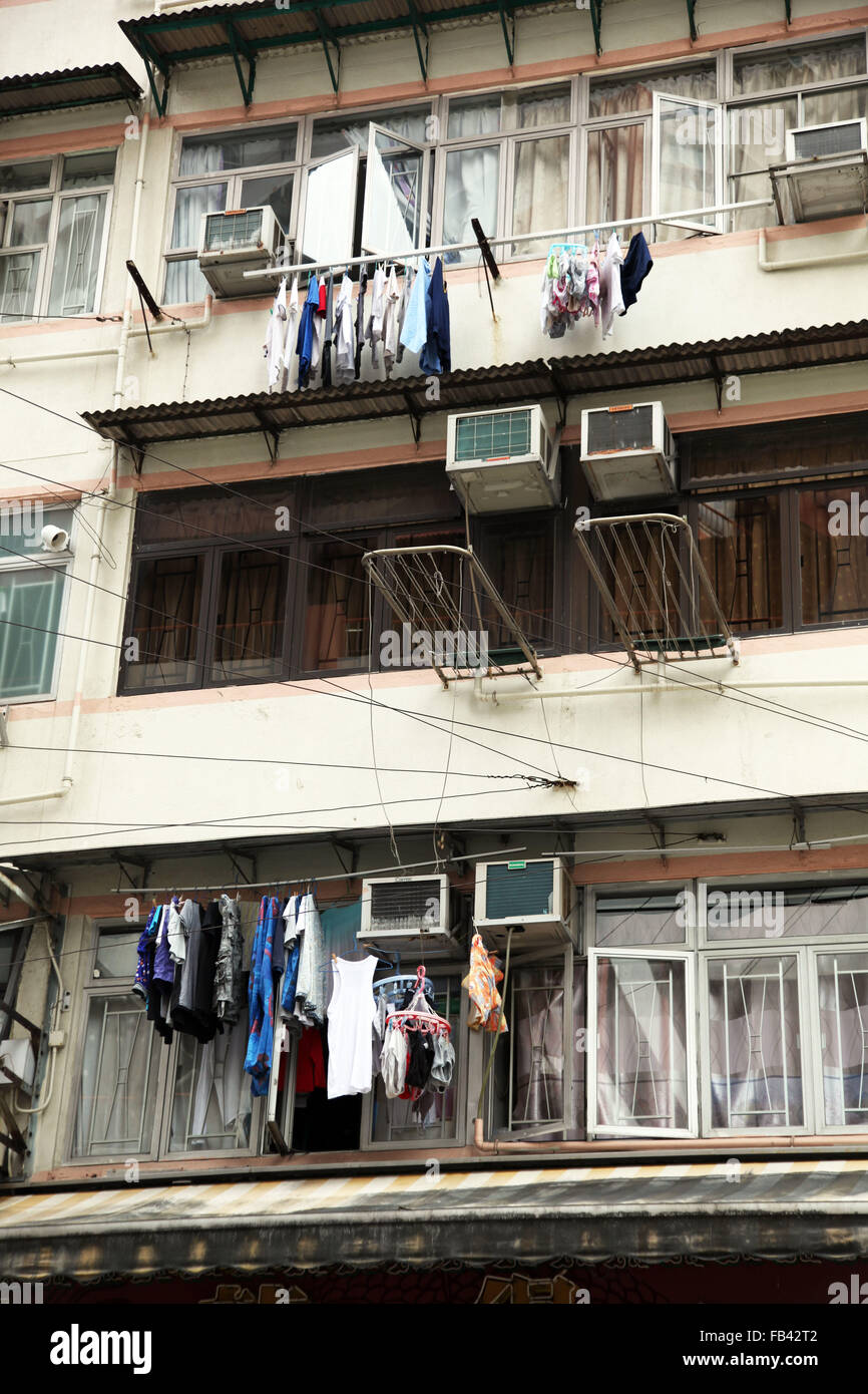 C'est une photo d'un détail d'un immeuble dans le quartier de Kowloon à Hong Kong, Chine. Nous pouvons voir des vêtements secs s'est pendu Banque D'Images