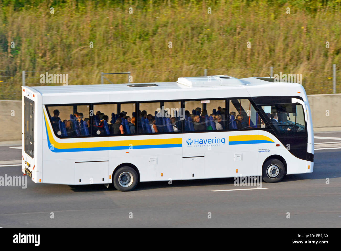 School bus exploités par London Borough of Havering en voiture sur autoroute M25 Essex England UK Banque D'Images