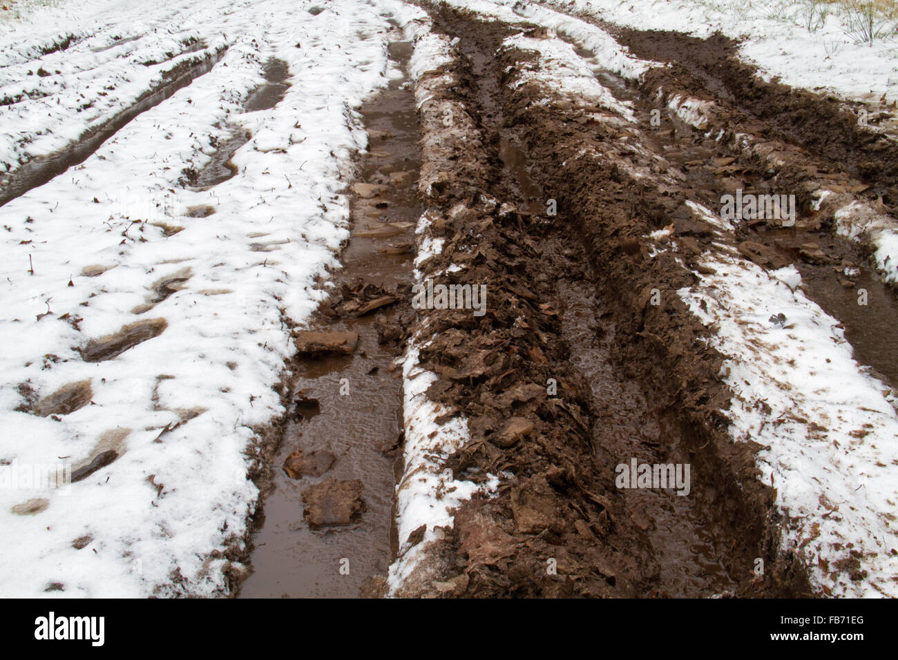 Le mauvais état des routes : la neige, la glace et la boue sur une route de campagne Banque D'Images