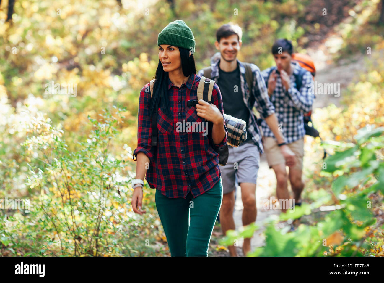 Jeune femme avec des amis de randonnée en forêt Banque D'Images