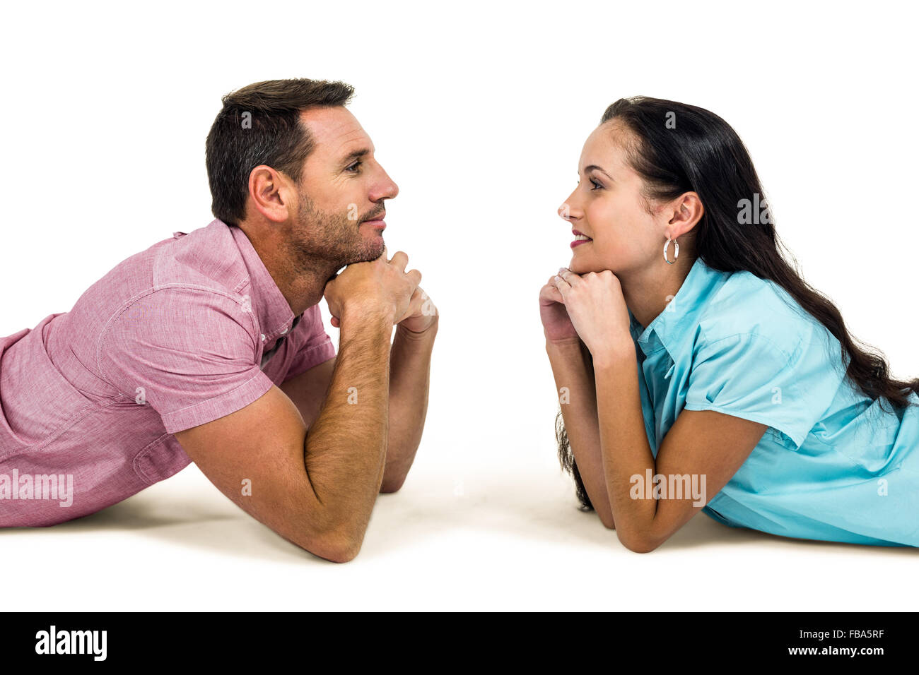 Heureux couple portant sur le plancher à l'un l'autre Banque D'Images