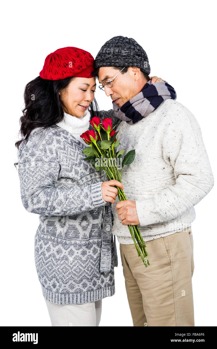 Older asian man giving sa femme fleurs Banque D'Images