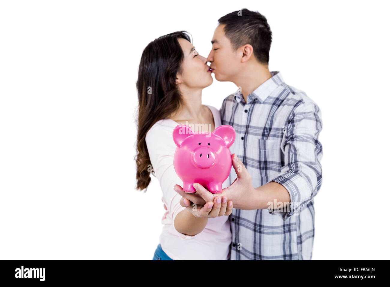 Couple tout en holding piggy bank Banque D'Images