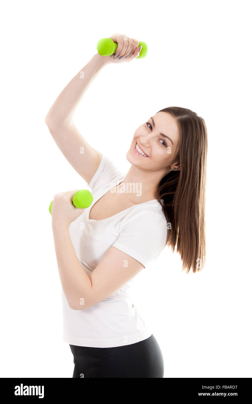 Young smiling woman in white t-shirt de couleur verte trains biceps haltère de levage de poids, entraînement, faire des exercices de remise en forme. La norme iso Banque D'Images