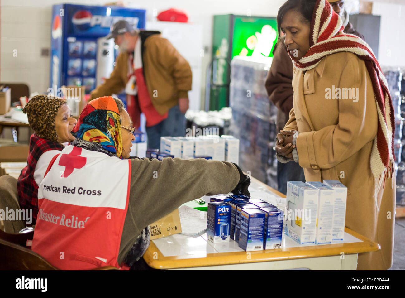 Flint, Michigan USA - 13 janvier 2016 - Les résidants pick up de l'eau en bouteille et des filtres à eau à partir de la Croix Rouge, les bénévoles de secours en cas de catastrophe à la Caserne # 6. L'eau et des filtres ont été distribués après la réduction des coûts par des fonctionnaires de l'état conduit à des niveaux élevés de plomb dans l'alimentation en eau de la ville. Crédit : Jim West/Alamy Live News Banque D'Images
