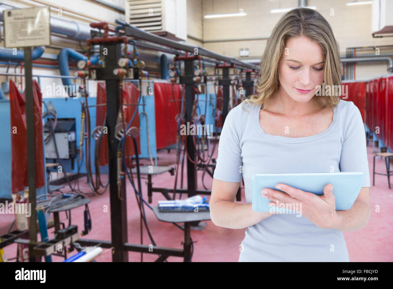 Image composite de woman using digital tablet Banque D'Images