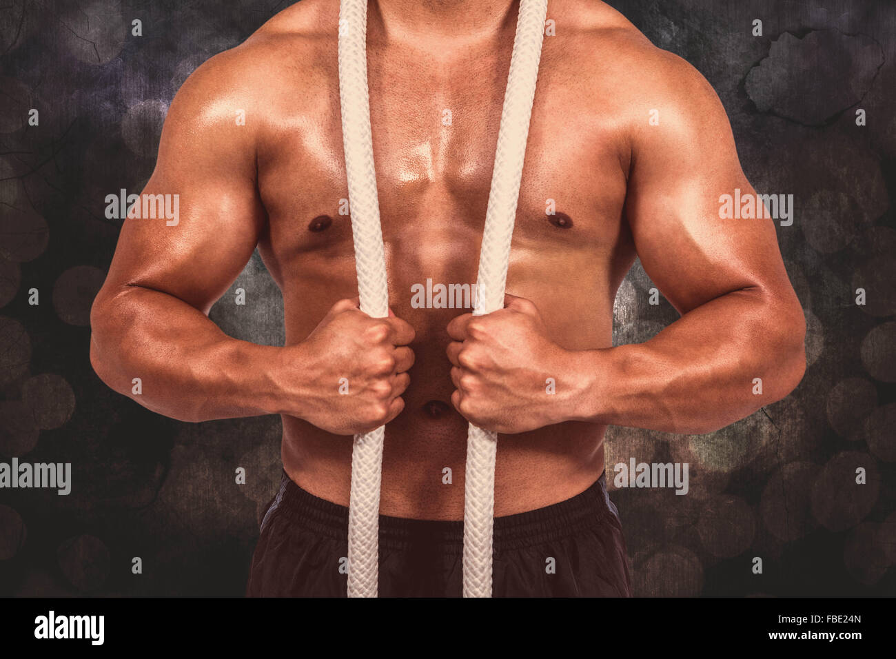 Image composite de l'homme musclé avec corde bataille Banque D'Images