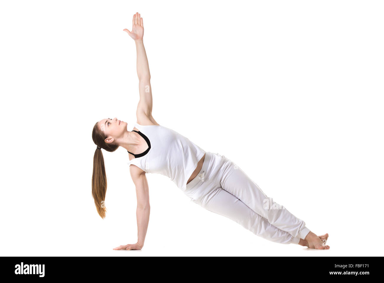 Young model in white fitness sportswear faisant du yoga ou de formation pilates, planche, Vasisthasana, front view Banque D'Images