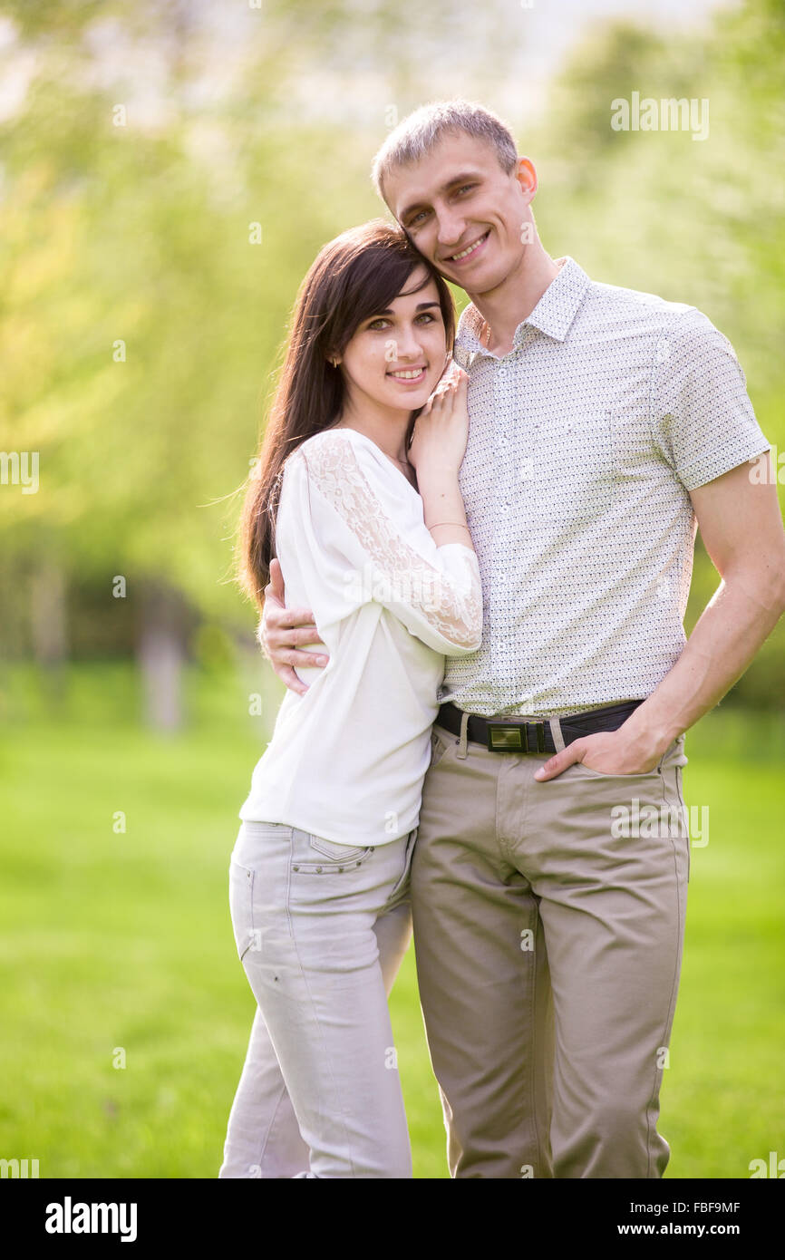 Portrait de couple heureux, jeune homme et femme sur la date dans park, étreignant l'un l'autre, appuyée sur son copain copine Banque D'Images
