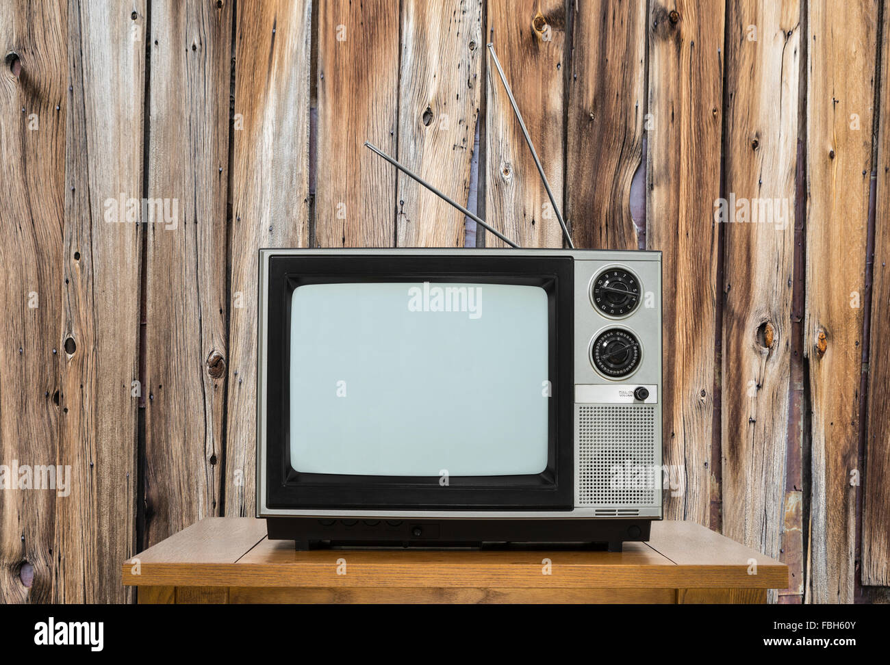 La télévision Vintage sur table avec mur en bois rustique. Banque D'Images