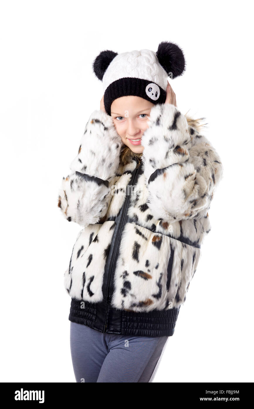 Portrait de funny belle casual caucasian teenage girl wearing white hat tricoté et manteau d'hiver, tremblant de froid, studio Banque D'Images