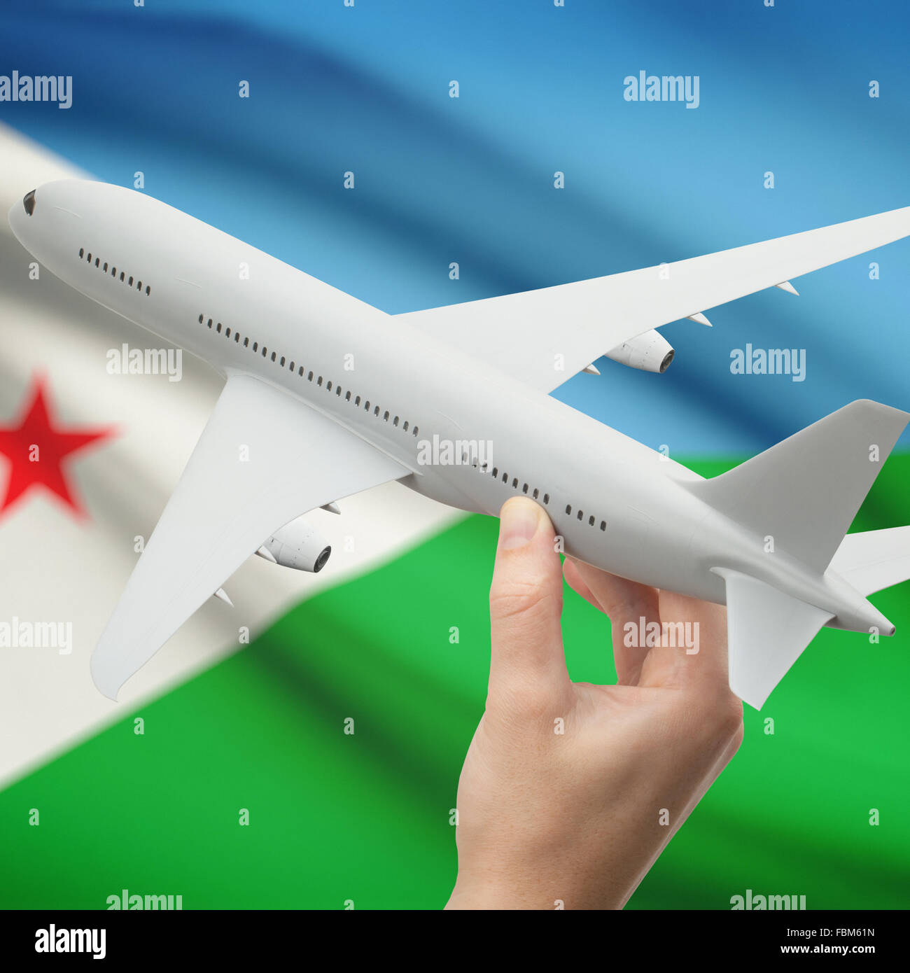 Avion en main avec drapeau national sur fond de série - Djibouti Banque D'Images