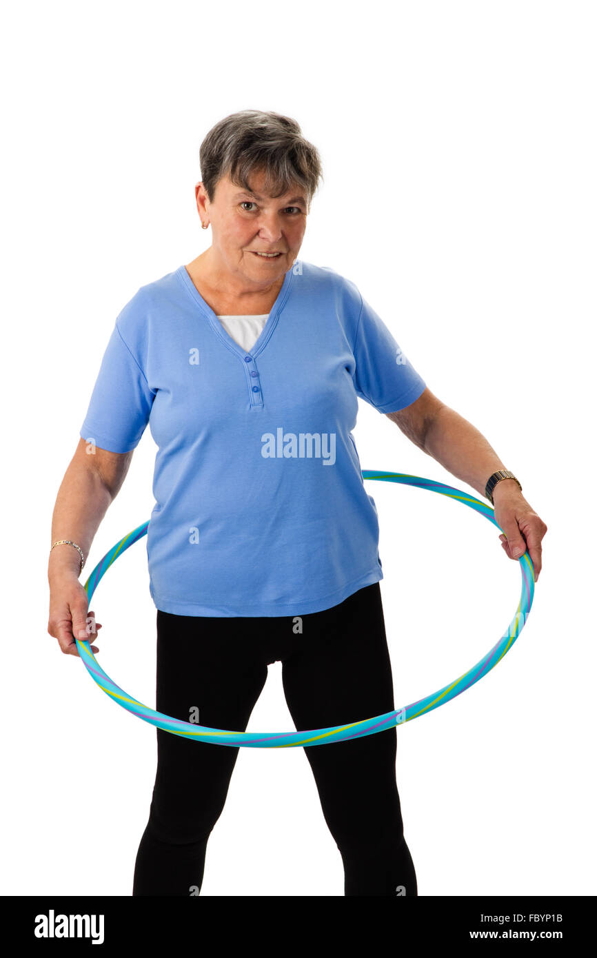 Senior woman exercising with hula-hoop Banque D'Images