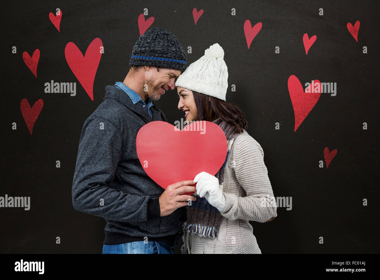 Image composite du couple festif dans les vêtements d'hiver Banque D'Images