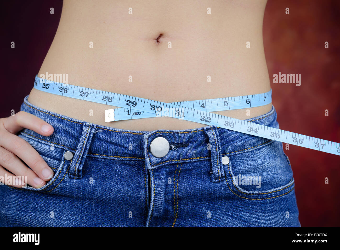 Femme asiatique slim , portant des jeans, la mesure de sa forme du corps, de la taille, des fesses Banque D'Images