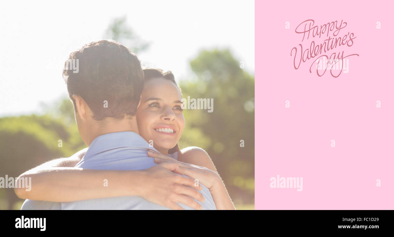 Image composite de l'amour et happy woman embracing man at park Banque D'Images