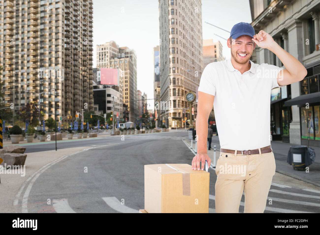 Composite image of delivery man leaning on trolley de boîtes Banque D'Images