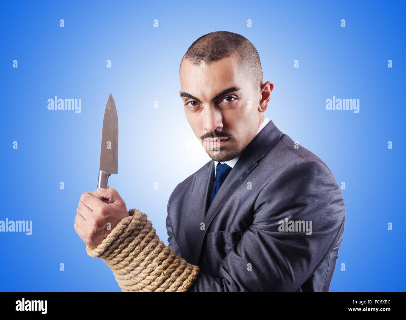 Businessman tied up avec corde Banque D'Images