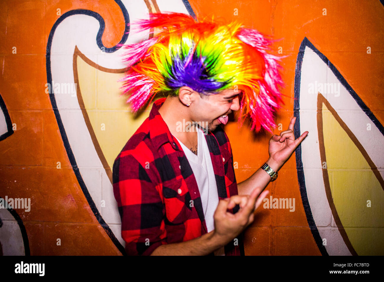 Hispanic man wearing colorful wig Banque D'Images