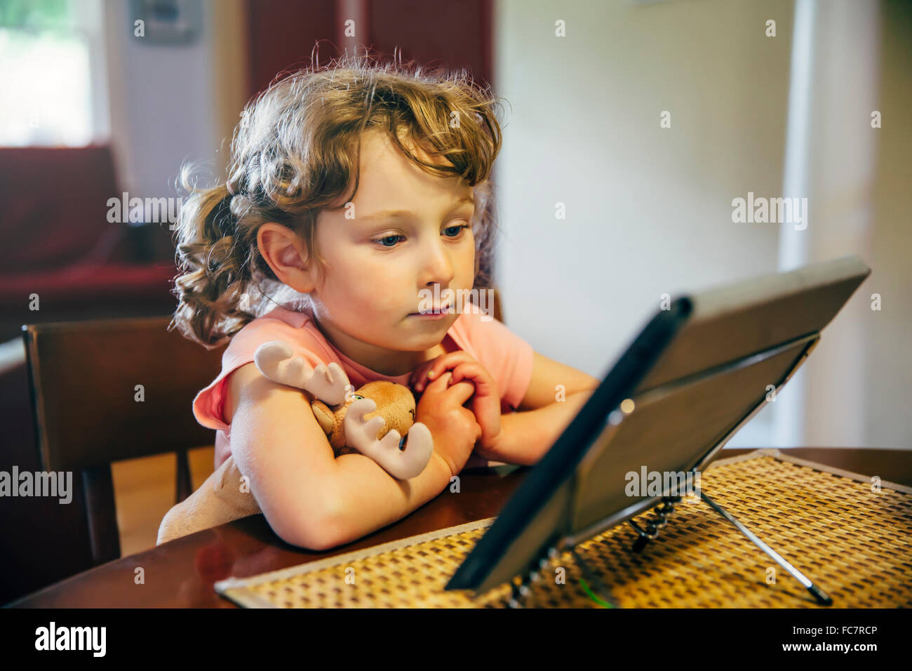 Caucasian girl watching digital tablet Banque D'Images