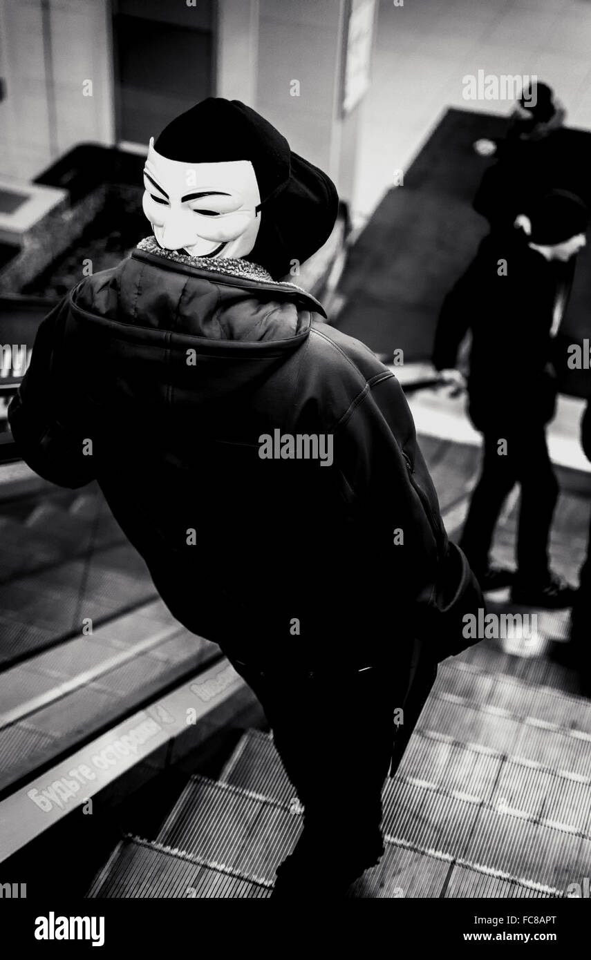 UFA - RUSSIE 19ème décembre 2015 - Jeune homme porte un masque de vendetta à l'arrière de sa tête alors qu'il utilise un escalator dans un style moderne Banque D'Images