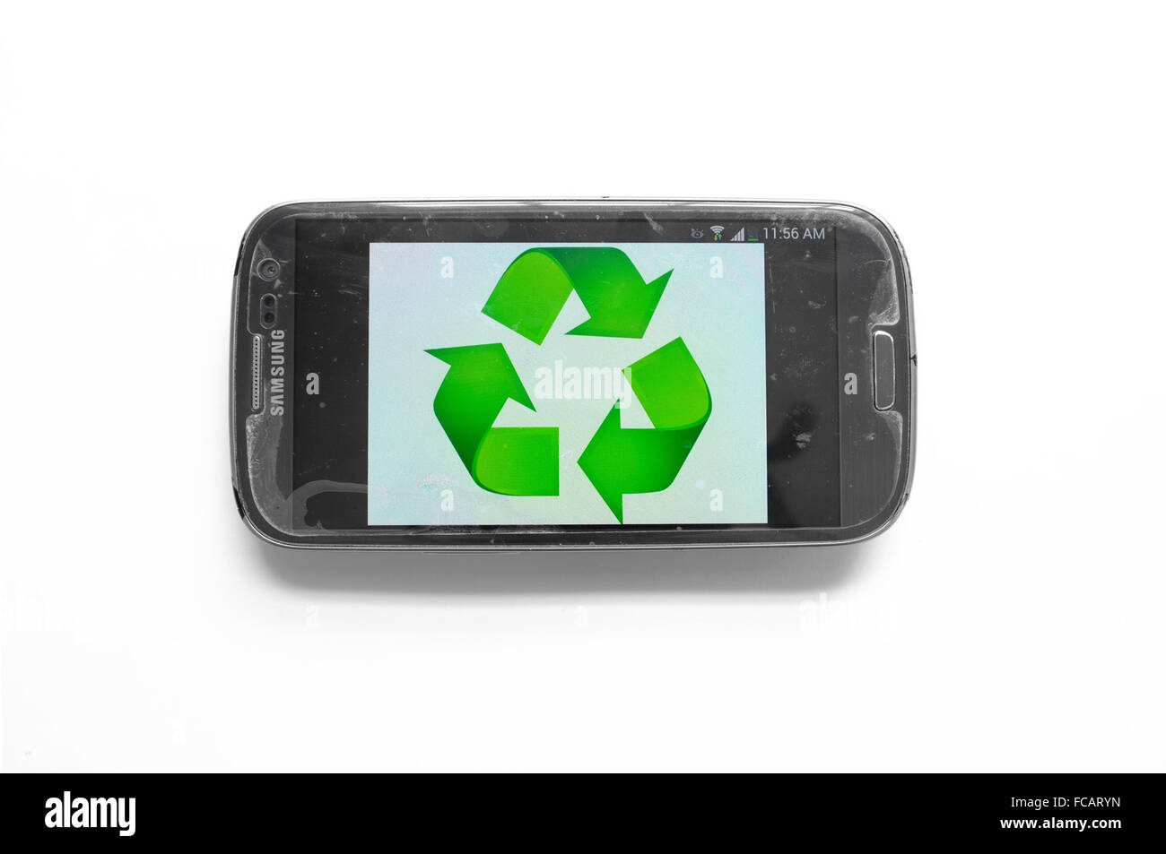 Le symbole de recyclage sur l'écran de smartphone photographié sur un fond blanc. Banque D'Images