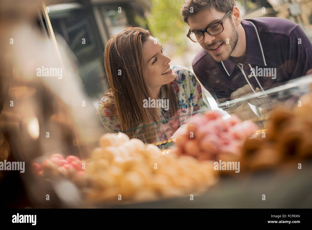 Un couple à la fenêtre à l'écran dans une confiserie. Banque D'Images