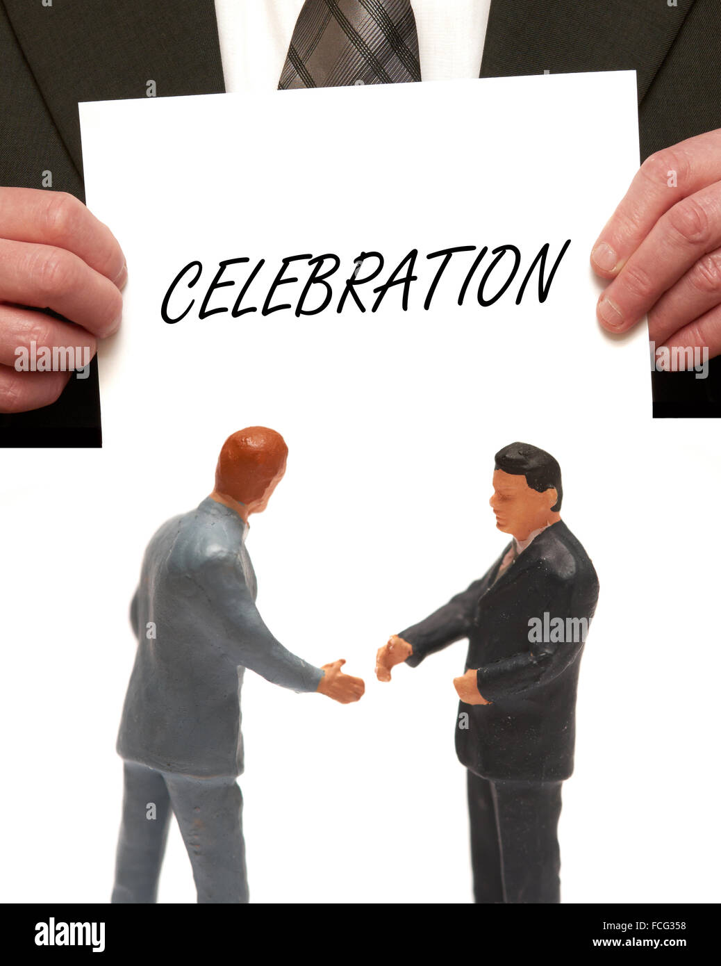 Célébration concept 2 miniatures en costumes shaking hands Banque D'Images