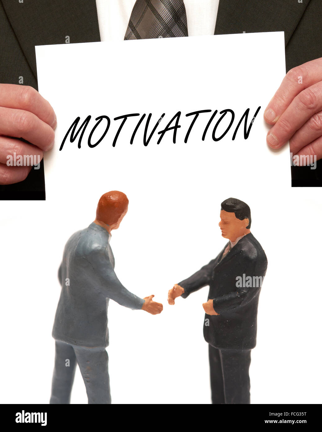 Concept de motivation 2 miniatures en costumes shaking hands Banque D'Images