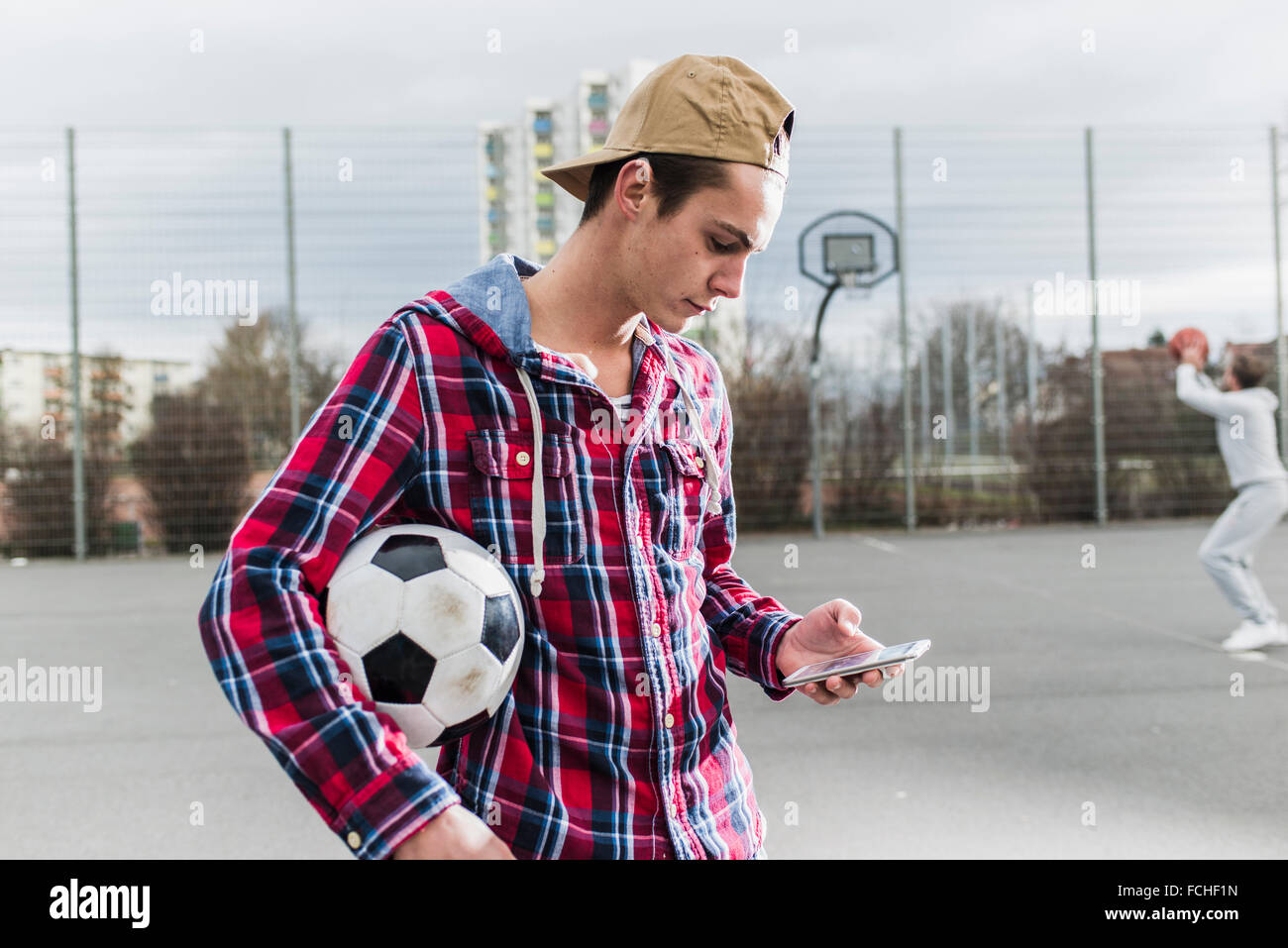 Young football player smartphone Blackberry Banque D'Images