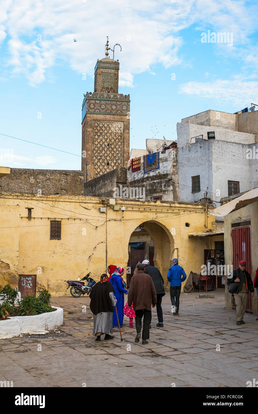 Les citoyens marocains dans une scène de la vie quotidienne à Fès El Jdid avec bab Moulay Abdellah minaret mosquée. Le Maroc. Banque D'Images