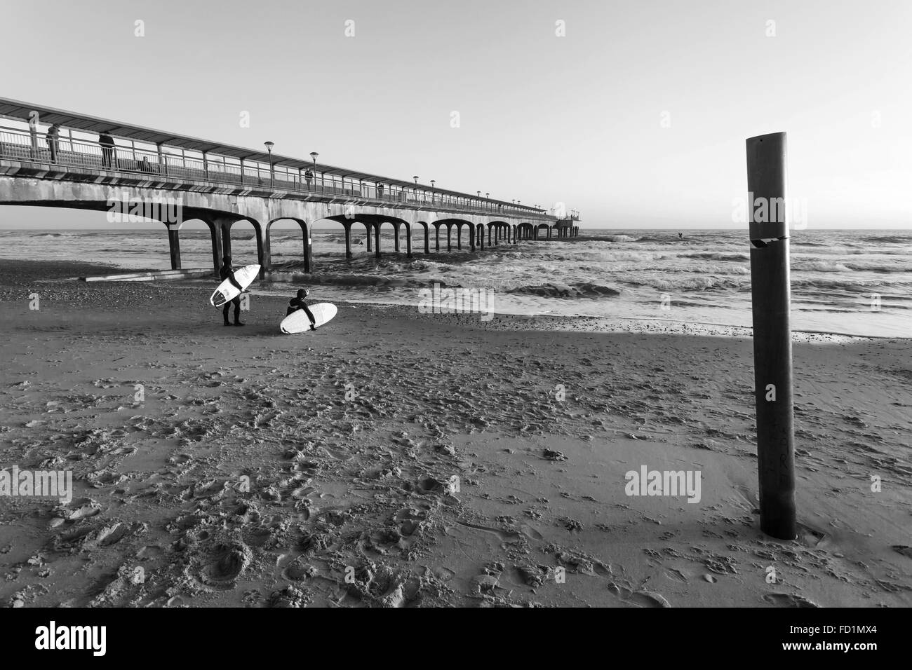 Deux surfeurs en vertu de Boscombe Pier Banque D'Images