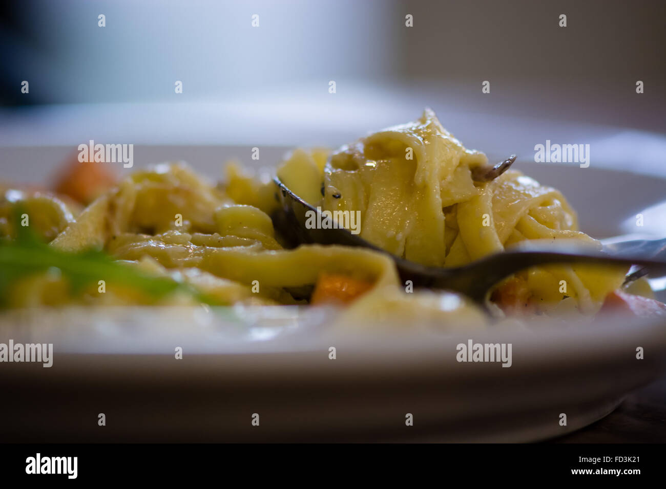 La patate douce, du fromage de chèvre et oignons rouges sur tagliatelles de cuillère côté. Plat de pâtes végétarien préparé par un chef français Banque D'Images