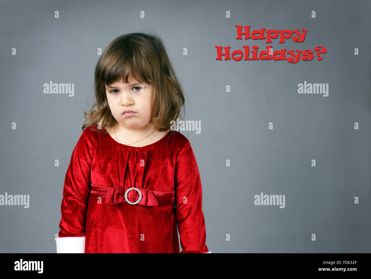 Cute little girl in red robe de Noël de bouder et lamentations Banque D'Images