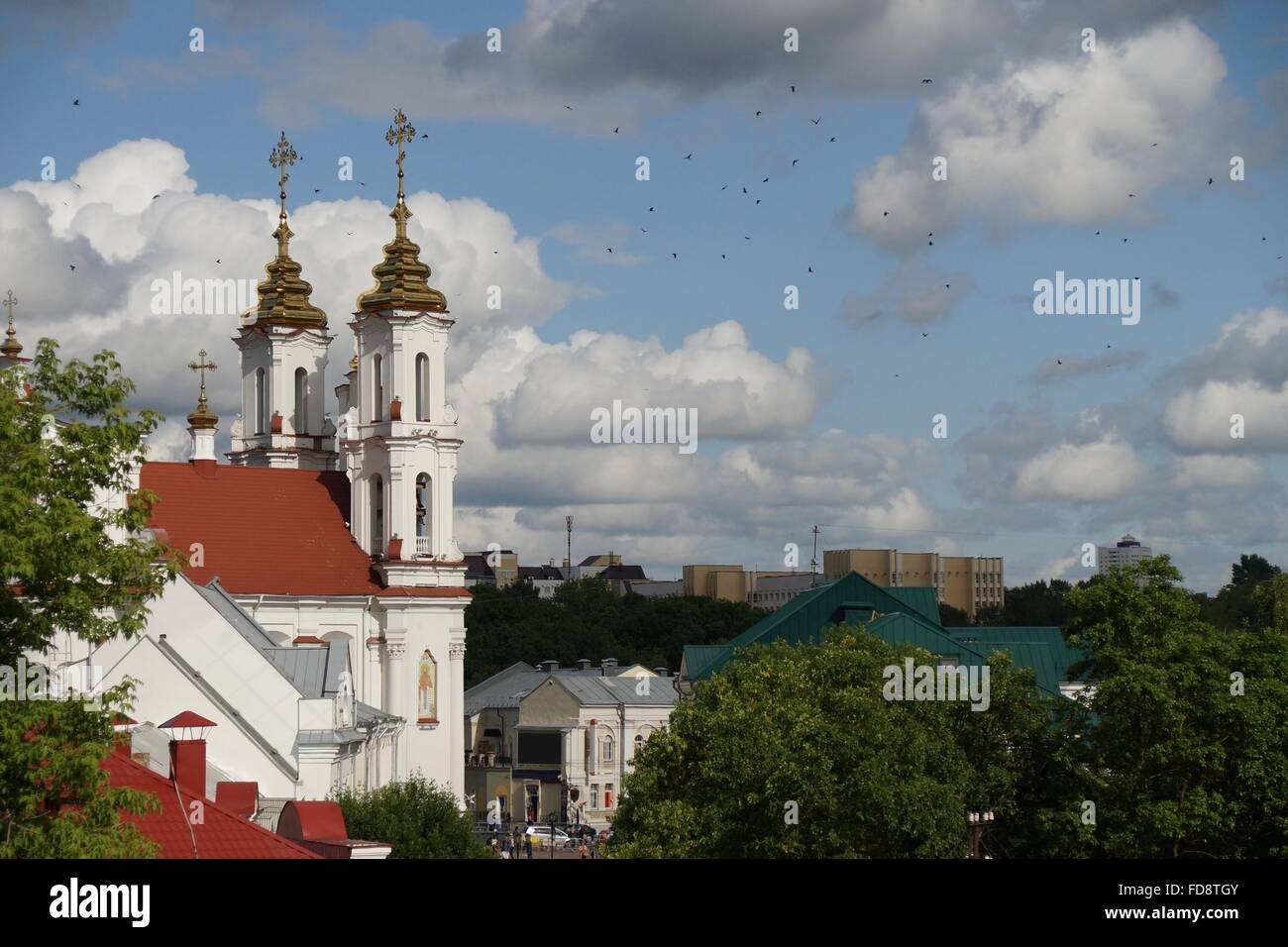 Avis de Voskresenskaya (Rynkovaya) Église, Vitebsk, Biélorussie par une belle journée ensoleillée avec de multiples oiseaux volant autour dans le ciel. Banque D'Images