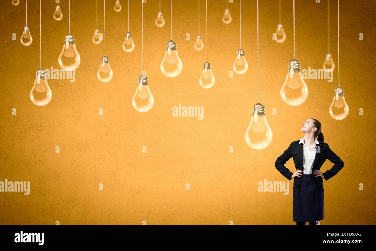 Concept de créativité avec femme et les ampoules qui pendait au-dessus Banque D'Images