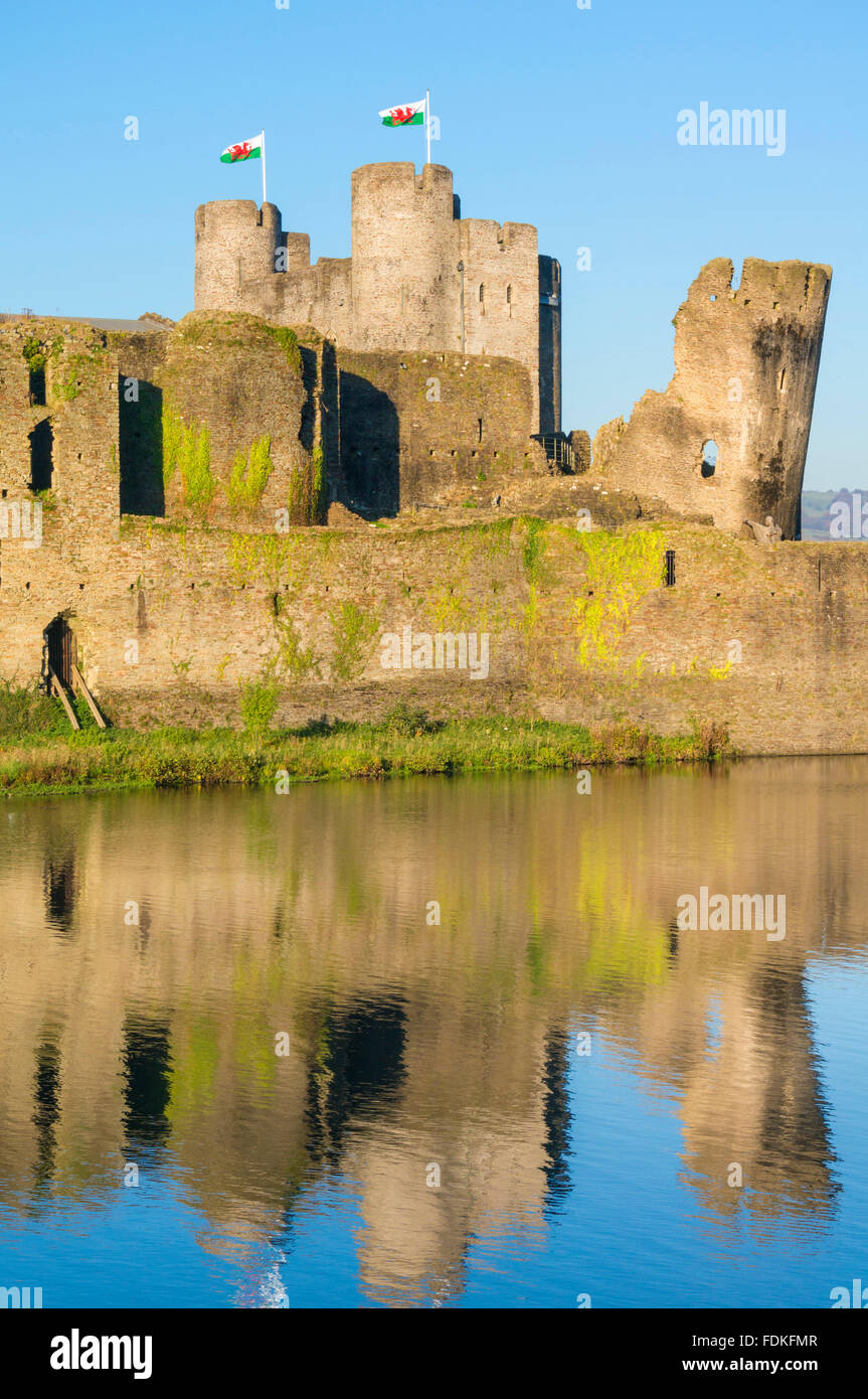 Volant au-dessus des drapeaux gallois Caerphilly Castle un château médiéval avec douves à Caerphilly Glamorgan South Wales GB UK EU Europe Banque D'Images