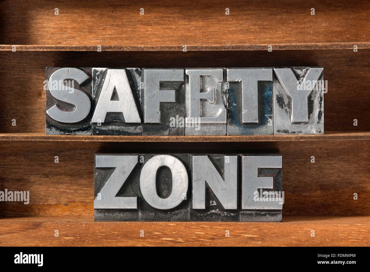 Zone de sécurité fabriqués à partir de la phrase type letterpress métallique sur plateau en bois Banque D'Images