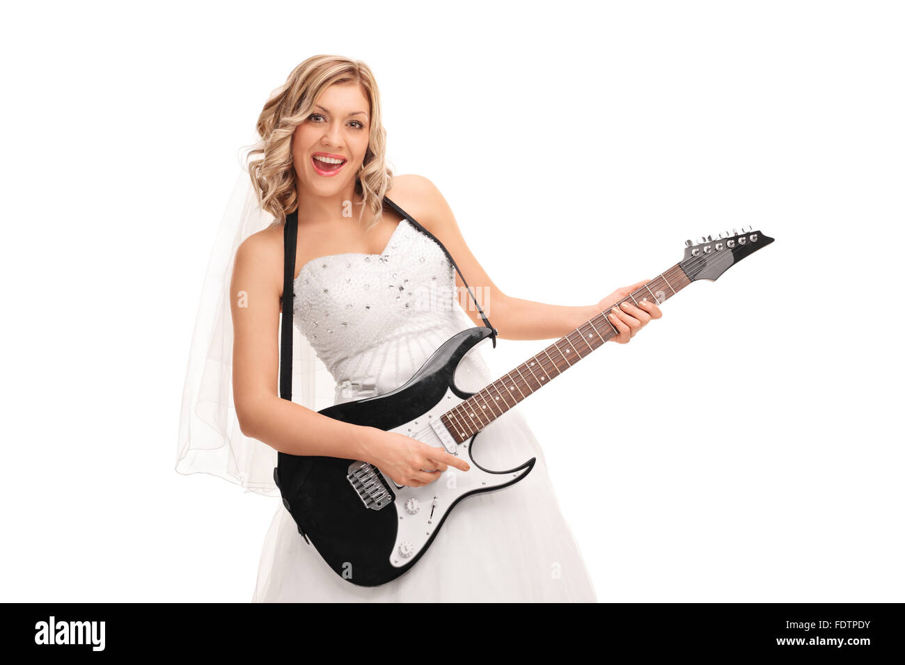 Jeune mariée joyeuse dans une robe de mariée blanche playing electric guitar isolé sur fond blanc Banque D'Images